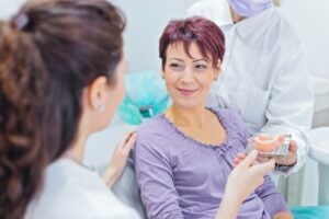 Happy Patient Smiling After Receiving Full and Flexible Partial Dentures at a Millersville, MD