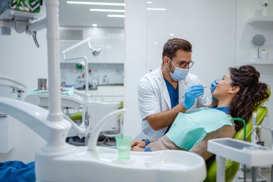 A dental professional is examining the oral health of a patient in Millersville, MD