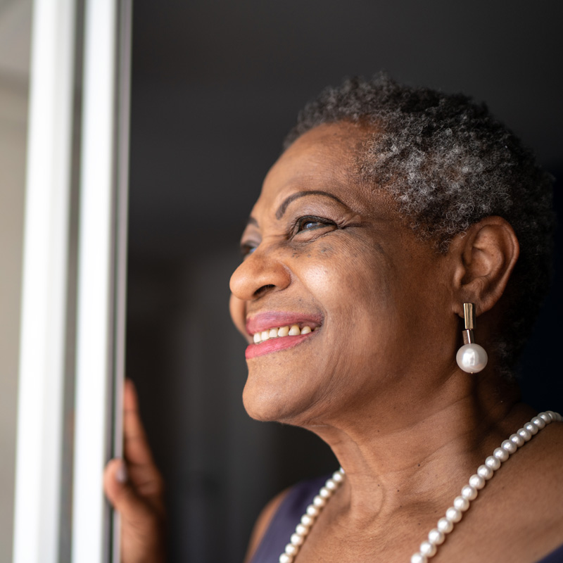 lady smiling looking out a window