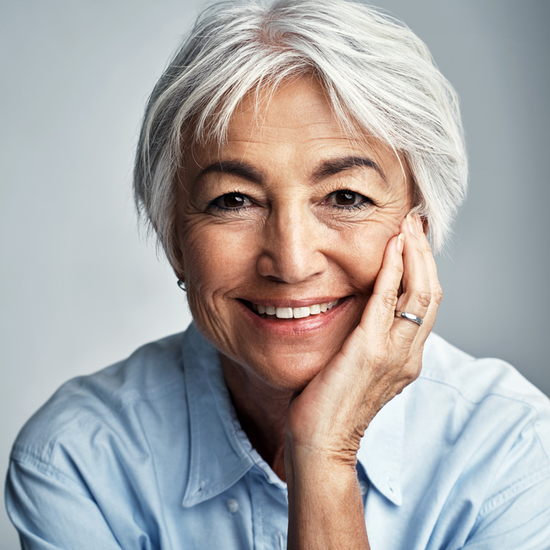 lady smiling with hand on face