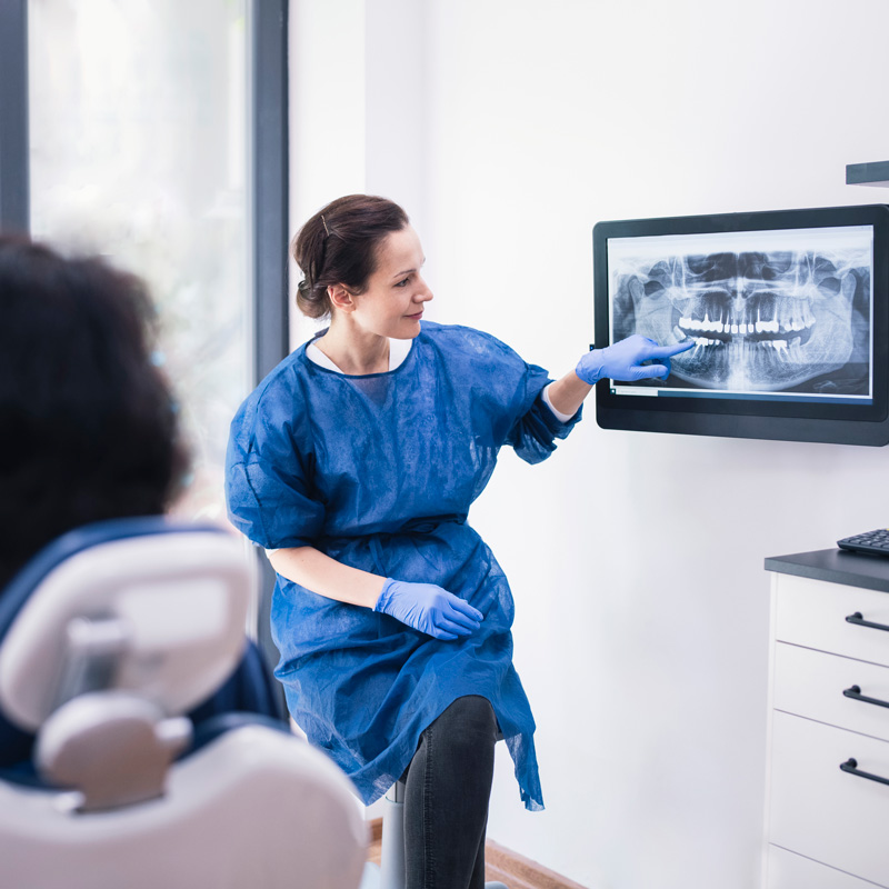 dentist showing patient xray of teeth