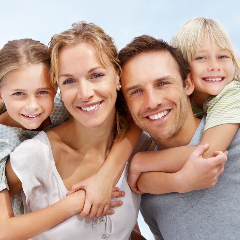 Family with bright smiles showing results of a smile makeover in Millersville, MD
