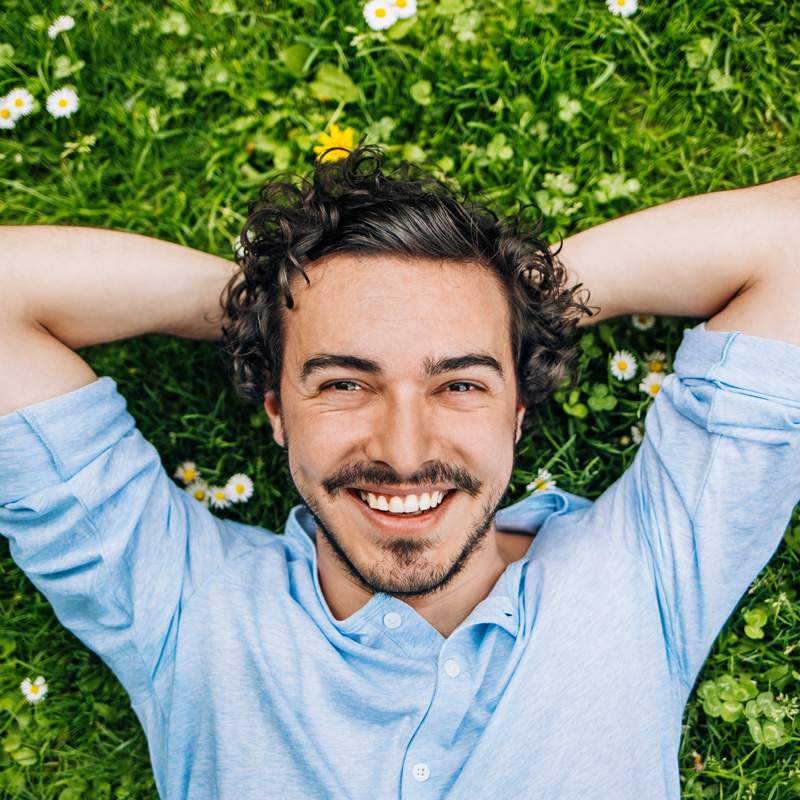Smiling person with bright teeth showing results of dental bonding in Millersville, MD